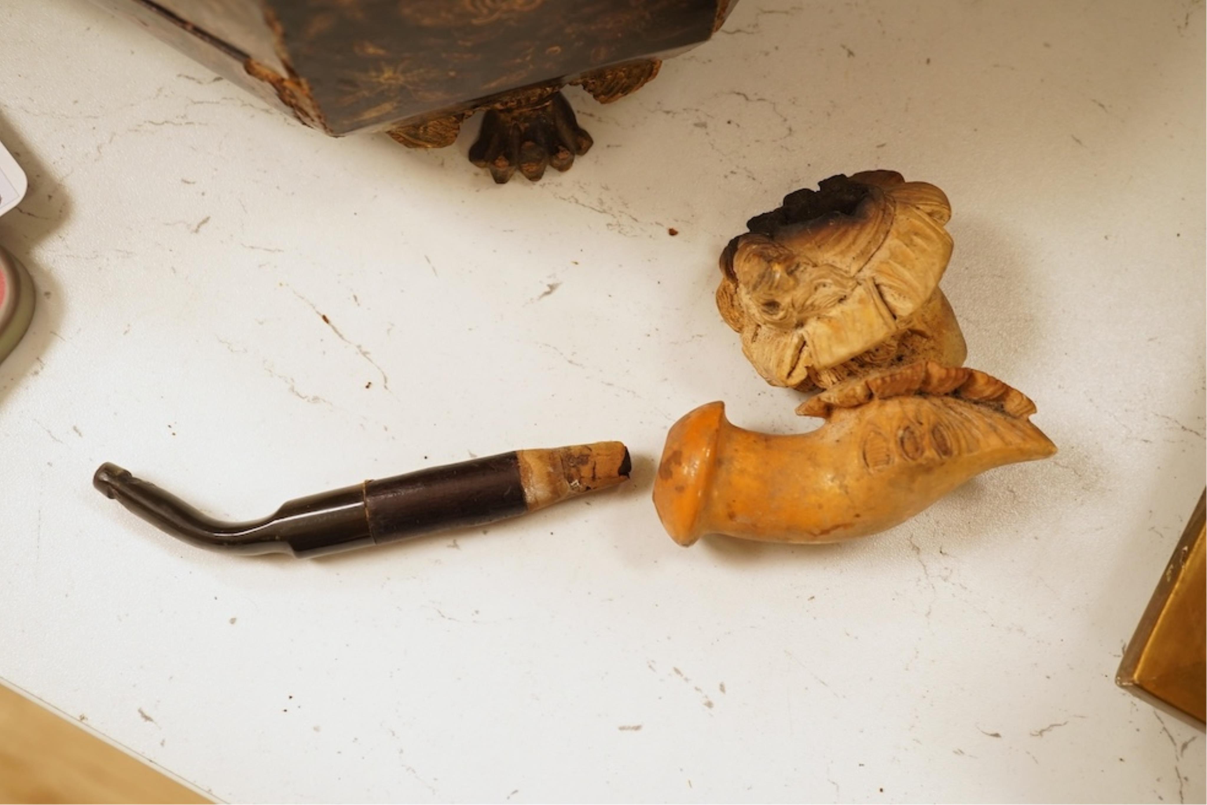 A 19th century German cold-painted terracotta bust, on ebonised socle and a Meerschaum pipe in case, bust 27cm high